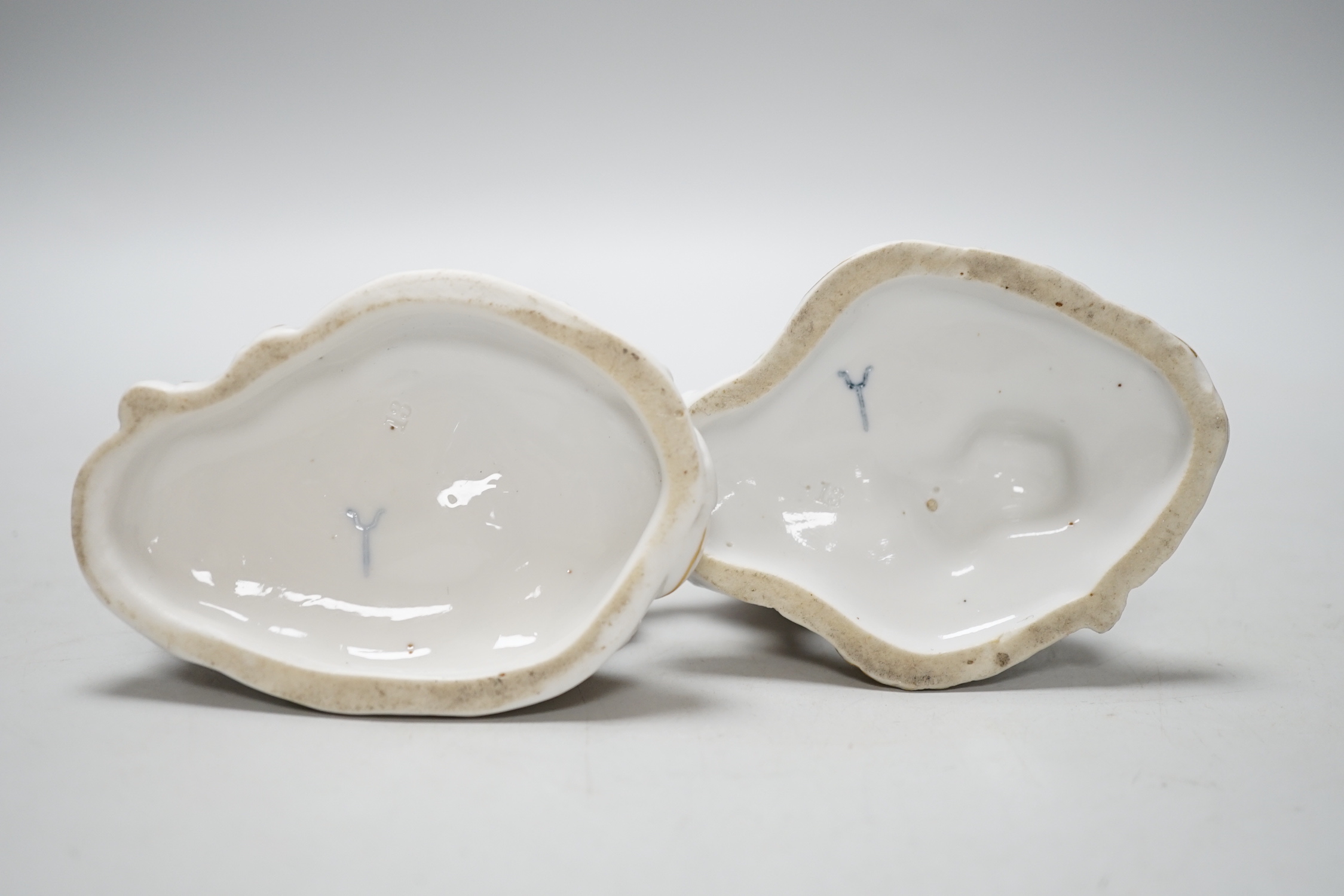 A pair of German Volkstedt porcelain figures including female with dragon, 15cm high